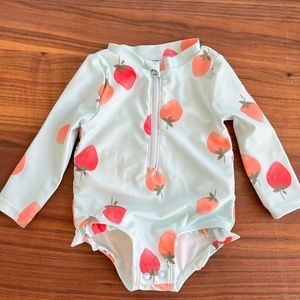 Carter’s long sleeved, one-piece swimsuit.